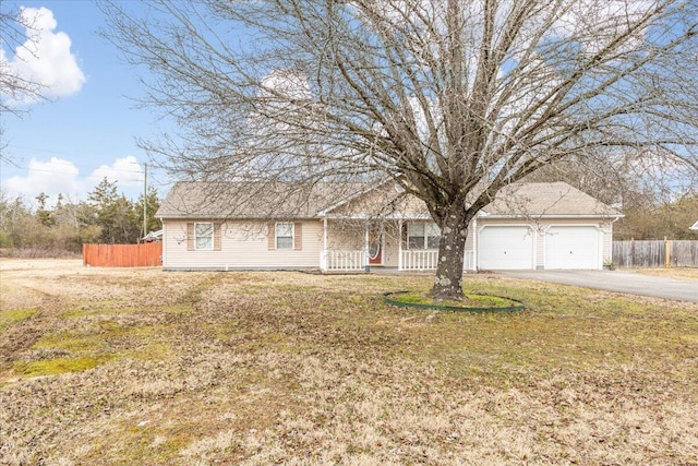 ranch-style house with a garage and a front lawn