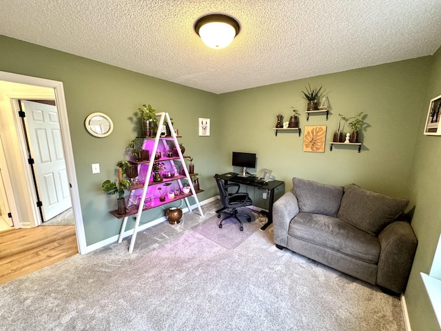 office area with carpet floors and a textured ceiling