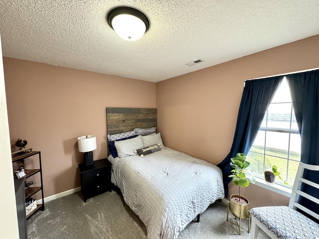 carpeted bedroom featuring a textured ceiling