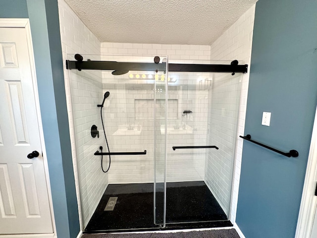 bathroom with an enclosed shower and a textured ceiling