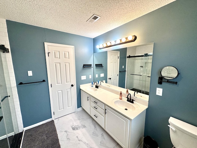 bathroom with vanity, an enclosed shower, a textured ceiling, and toilet