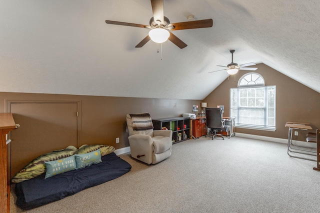 interior space featuring vaulted ceiling, ceiling fan, carpet floors, and a textured ceiling