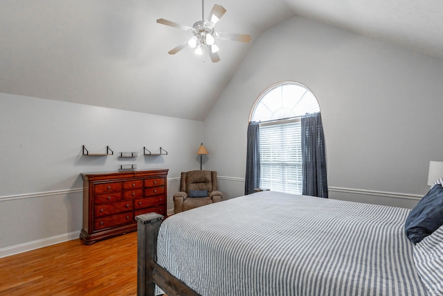 bedroom with hardwood / wood-style flooring, vaulted ceiling, and ceiling fan