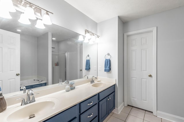 bathroom featuring vanity, independent shower and bath, tile patterned flooring, and a textured ceiling