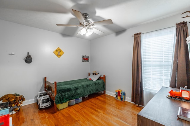 bedroom with ceiling fan and hardwood / wood-style floors