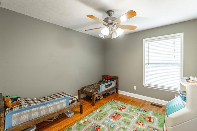 bedroom featuring hardwood / wood-style flooring and ceiling fan