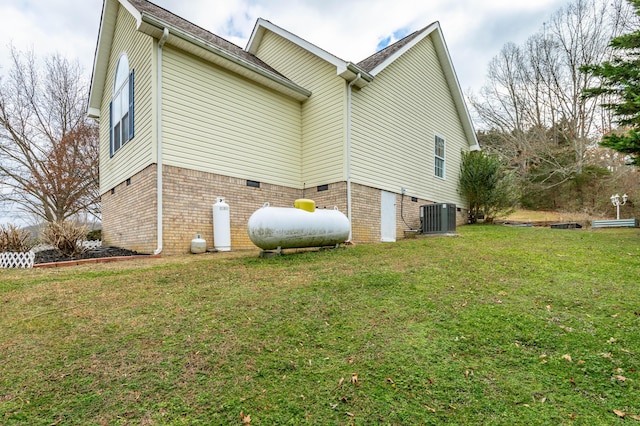 view of property exterior with a yard and central AC