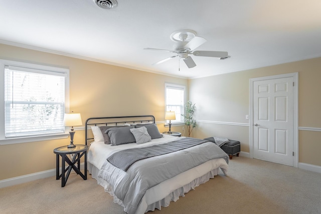 carpeted bedroom featuring crown molding and ceiling fan