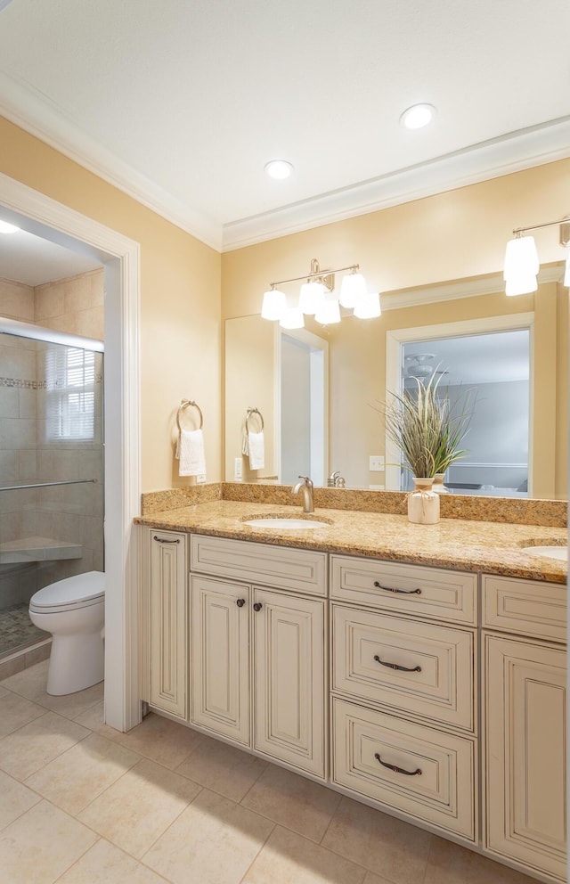 bathroom with toilet, crown molding, vanity, a shower with door, and tile patterned flooring