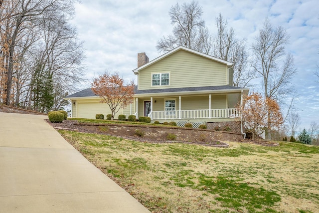 view of front of property featuring a front yard and covered porch