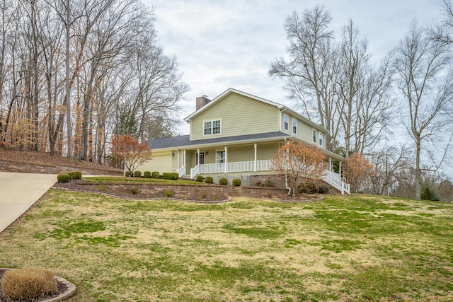 view of front of property with a garage, covered porch, and a front lawn