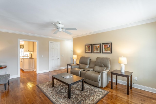 living room featuring hardwood / wood-style flooring, ceiling fan, and ornamental molding