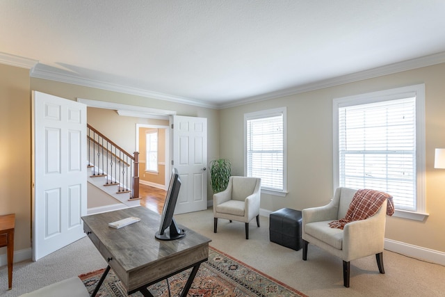 sitting room featuring light colored carpet, a wealth of natural light, and ornamental molding