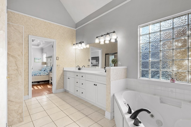 bathroom featuring lofted ceiling, vanity, a washtub, crown molding, and tile patterned floors