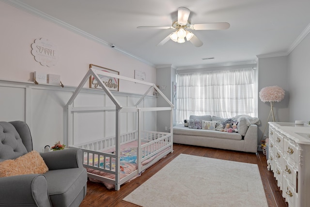 bedroom with crown molding, dark wood-type flooring, and ceiling fan