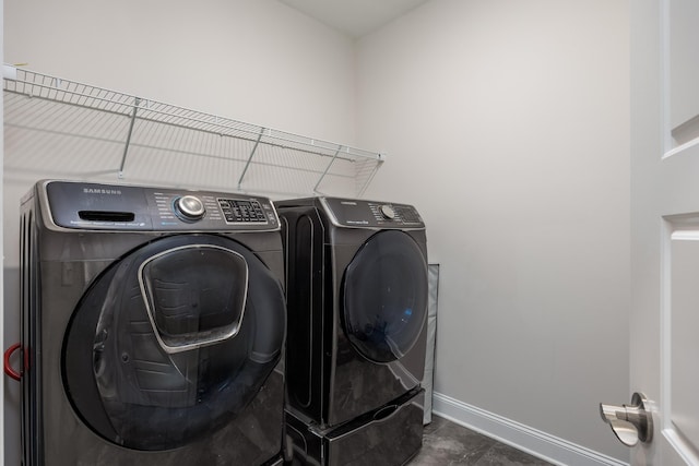 washroom with washing machine and clothes dryer