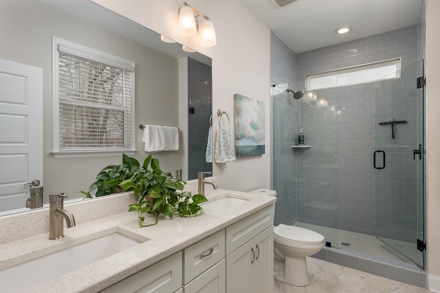 bathroom with vanity, toilet, and walk in shower