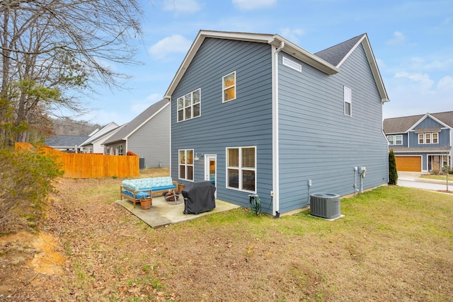 rear view of house with a patio area, central air condition unit, and a lawn