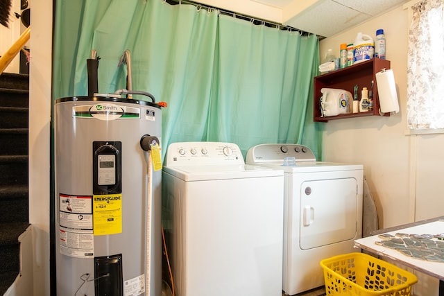 laundry room featuring electric water heater and independent washer and dryer