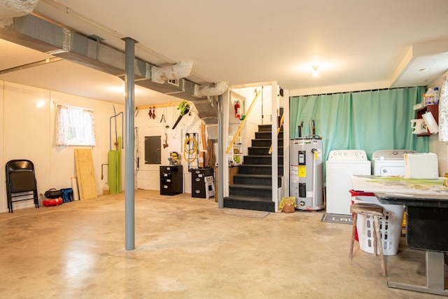 basement featuring electric water heater, washing machine and clothes dryer, and electric panel