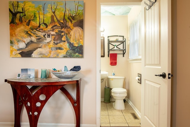 bathroom with tile patterned floors and toilet