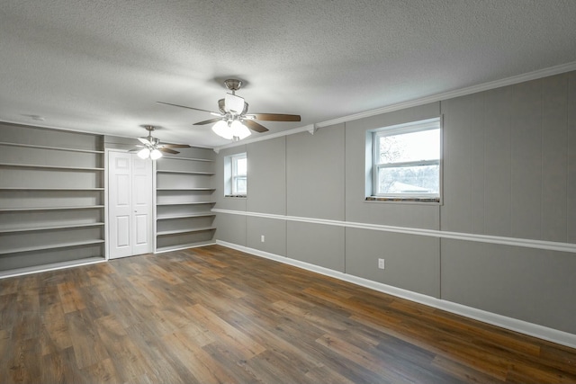 unfurnished bedroom with dark wood-type flooring, ornamental molding, and multiple windows