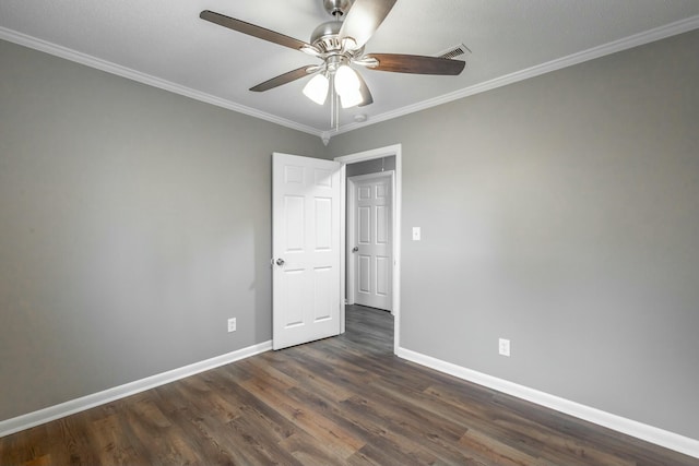 empty room with ceiling fan, ornamental molding, and dark hardwood / wood-style flooring