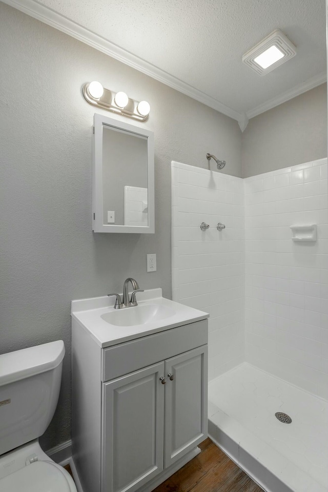 bathroom featuring walk in shower, toilet, crown molding, a textured ceiling, and hardwood / wood-style floors