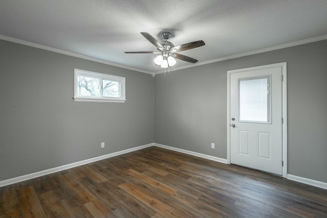 spare room featuring ornamental molding, dark hardwood / wood-style floors, and a textured ceiling