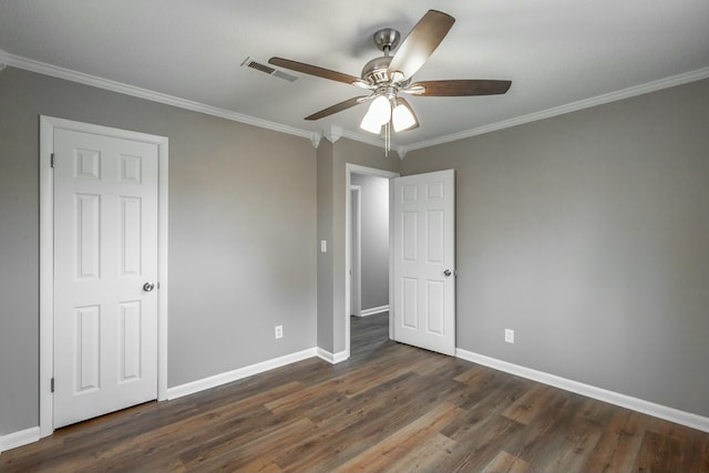 unfurnished bedroom featuring crown molding, ceiling fan, and dark hardwood / wood-style flooring