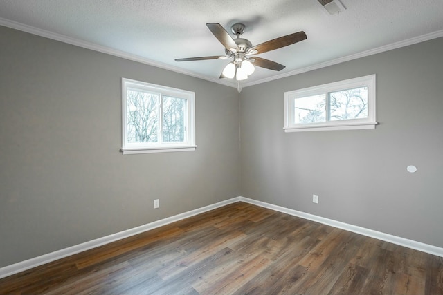 spare room featuring crown molding, dark wood-type flooring, a textured ceiling, and ceiling fan