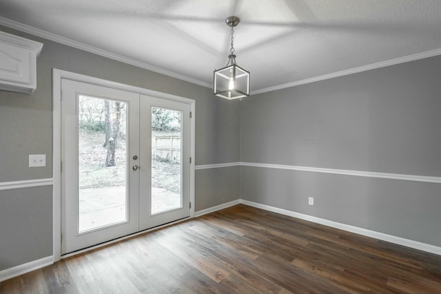 entryway featuring french doors, ornamental molding, dark wood-type flooring, and a textured ceiling