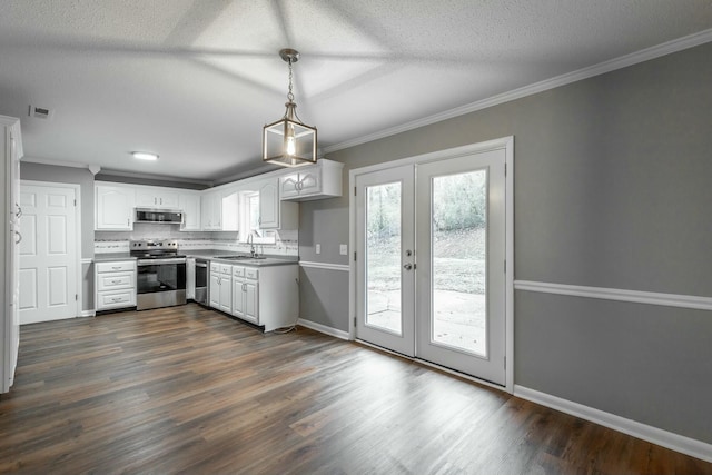 kitchen featuring pendant lighting, stainless steel appliances, ornamental molding, white cabinets, and french doors