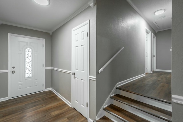 foyer entrance with dark wood-type flooring and ornamental molding