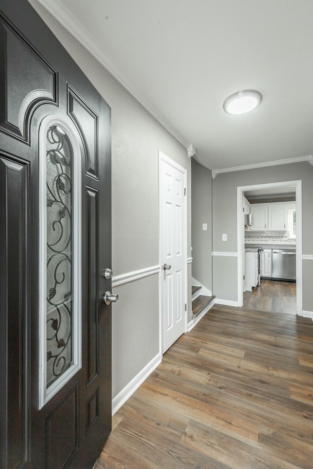 entryway with hardwood / wood-style flooring and ornamental molding