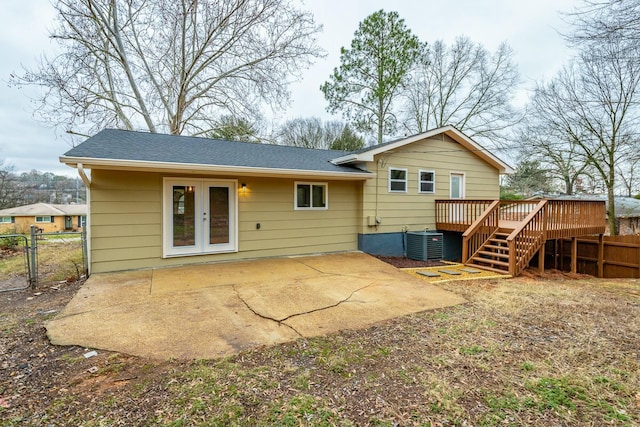 back of property with a wooden deck, central AC unit, a patio area, and french doors