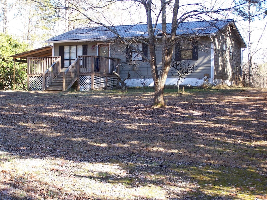 rear view of house featuring a deck