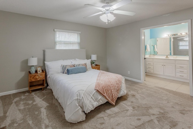 carpeted bedroom featuring sink, ceiling fan, and ensuite bathroom