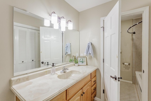 bathroom featuring tile patterned floors, vanity, and tiled shower / bath combo