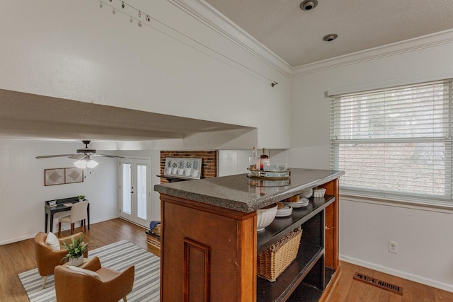 kitchen featuring crown molding, wood-type flooring, and ceiling fan