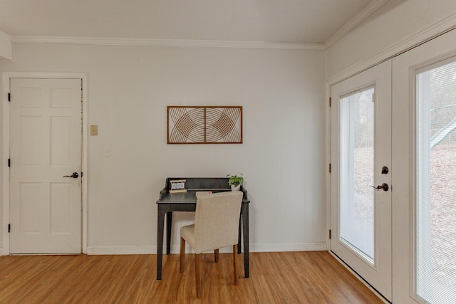 office with ornamental molding, light hardwood / wood-style flooring, and french doors