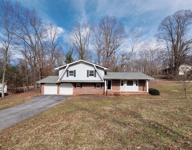 tri-level home with driveway, brick siding, a front lawn, and a gambrel roof