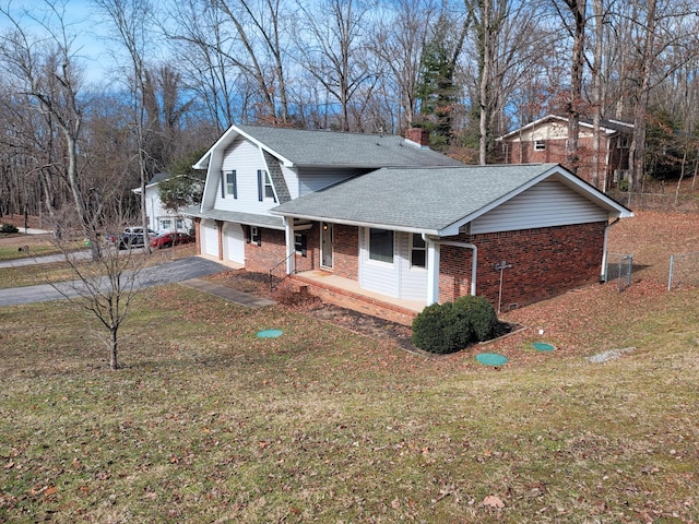 view of side of property with a chimney, aphalt driveway, roof with shingles, a porch, and brick siding