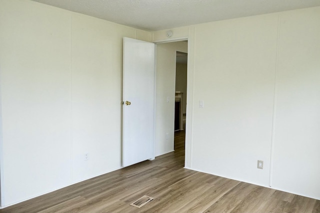 spare room featuring light hardwood / wood-style floors