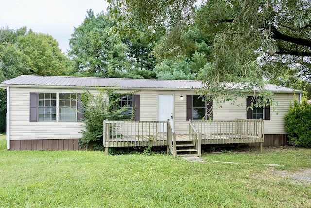 back of property featuring a lawn and a deck