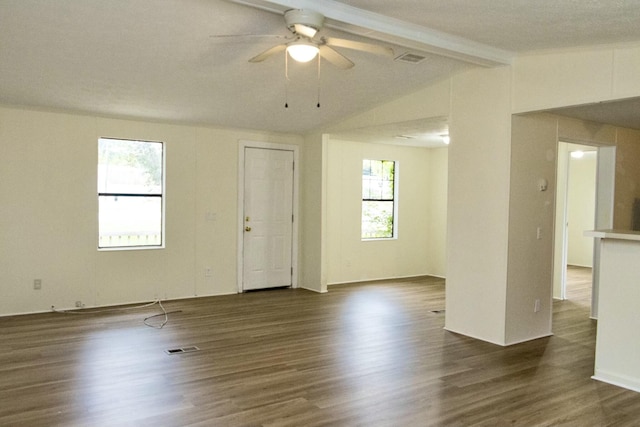 spare room with dark hardwood / wood-style flooring, vaulted ceiling with beams, and ceiling fan