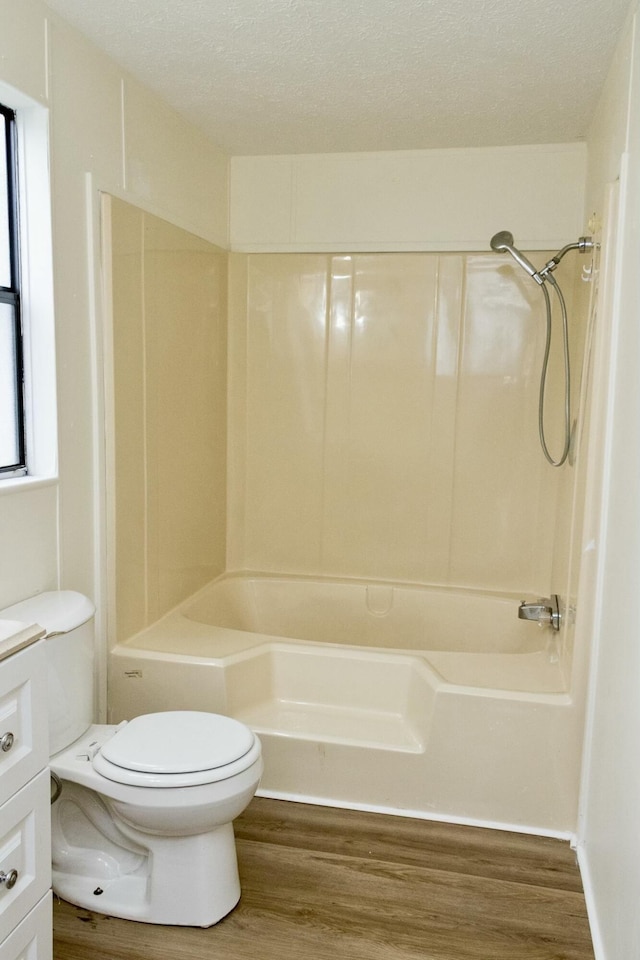 full bathroom with shower / bathtub combination, vanity, toilet, and hardwood / wood-style floors