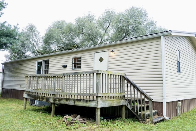 rear view of house featuring a wooden deck