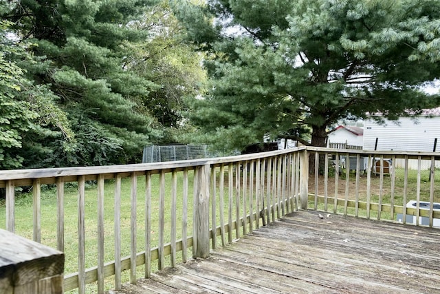 wooden deck featuring a lawn