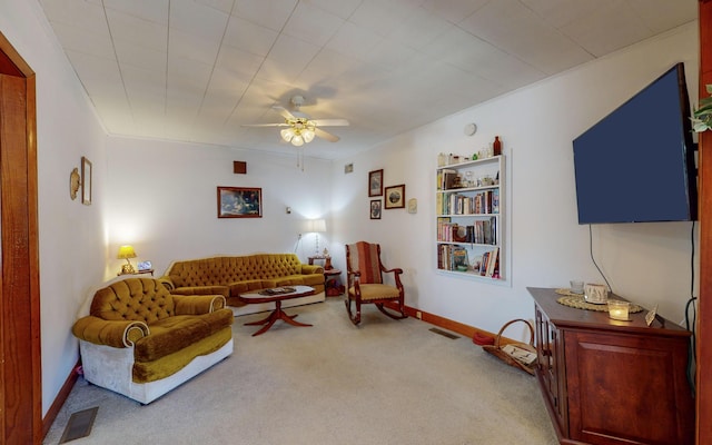 carpeted living room with ceiling fan